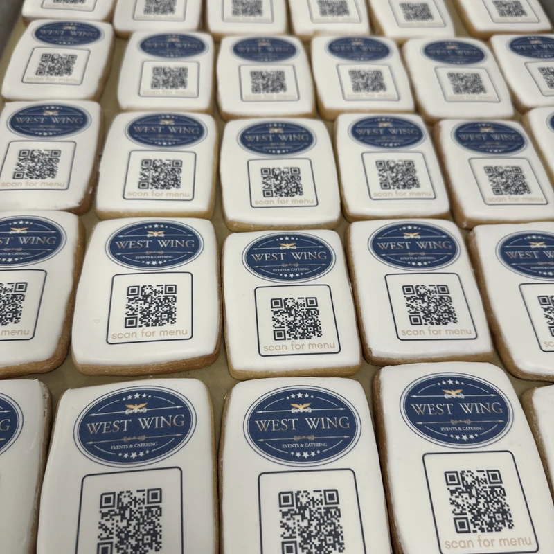 Rows of West Wing logo cookies next to QR code cookies.