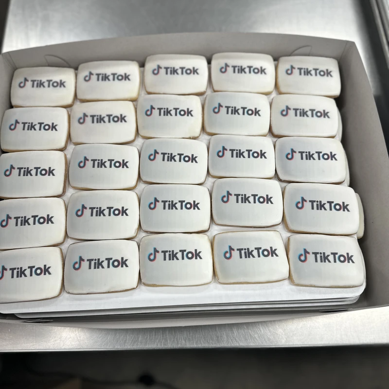 A box of square cookies printed with the TikTok logo.
