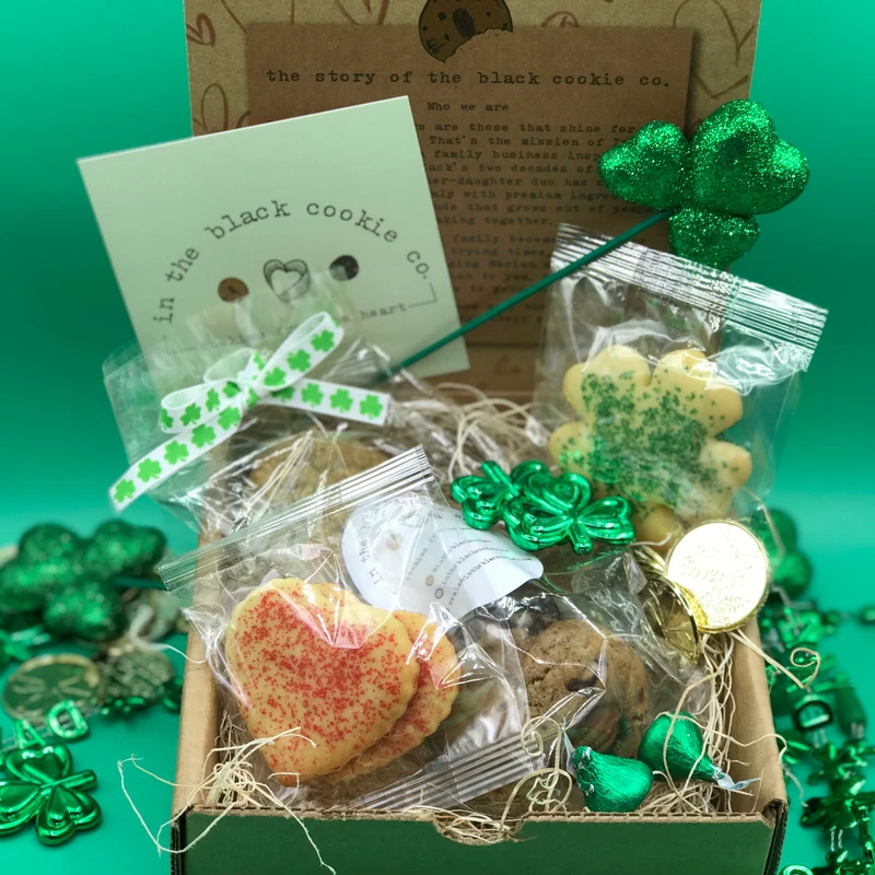 Luck of the Irish box with a pink heart cookie, clover cookies and green shamrock decorations