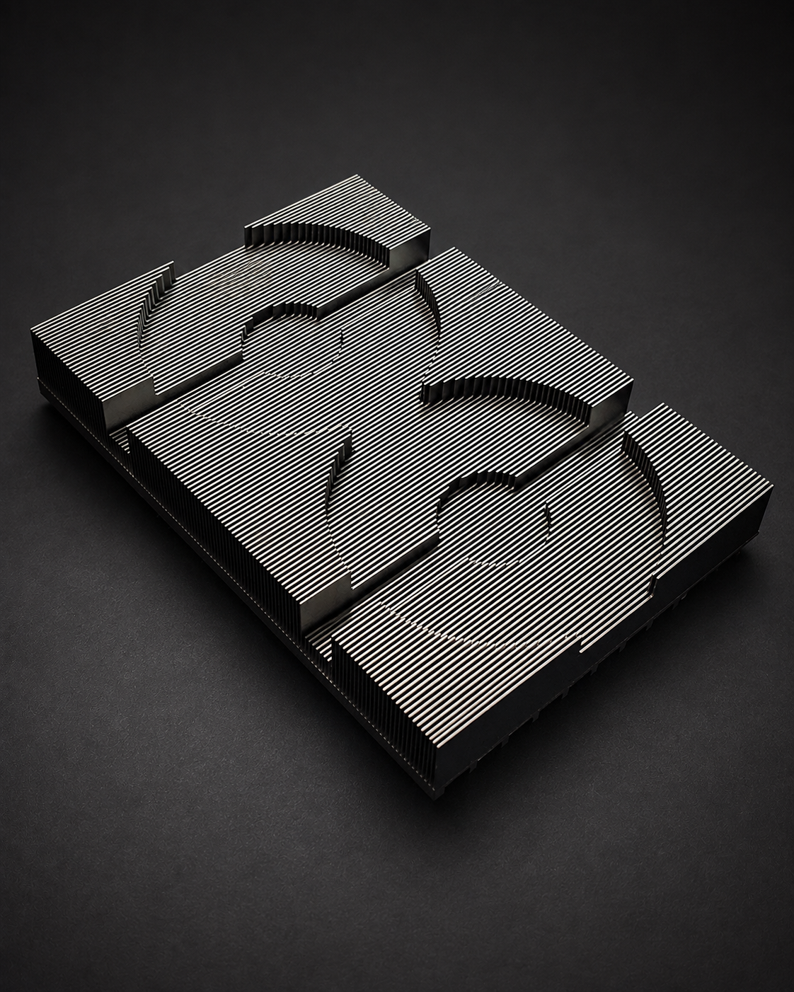 Fin array with shaped clearances photographed on a dark surface.