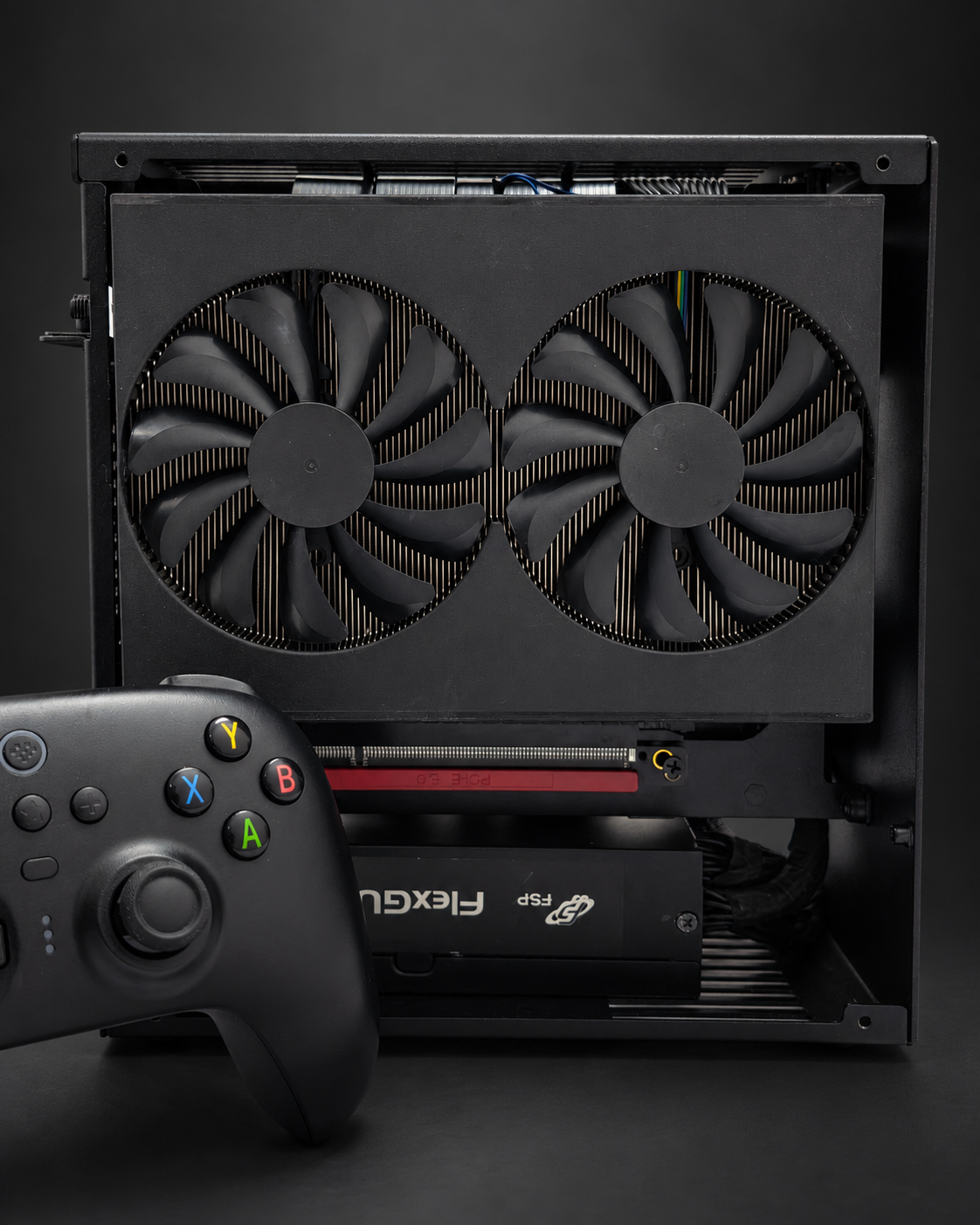 Front view of the GRAVE prototype showing the dual-fan graphics-side assembly, with a controller in the foreground.