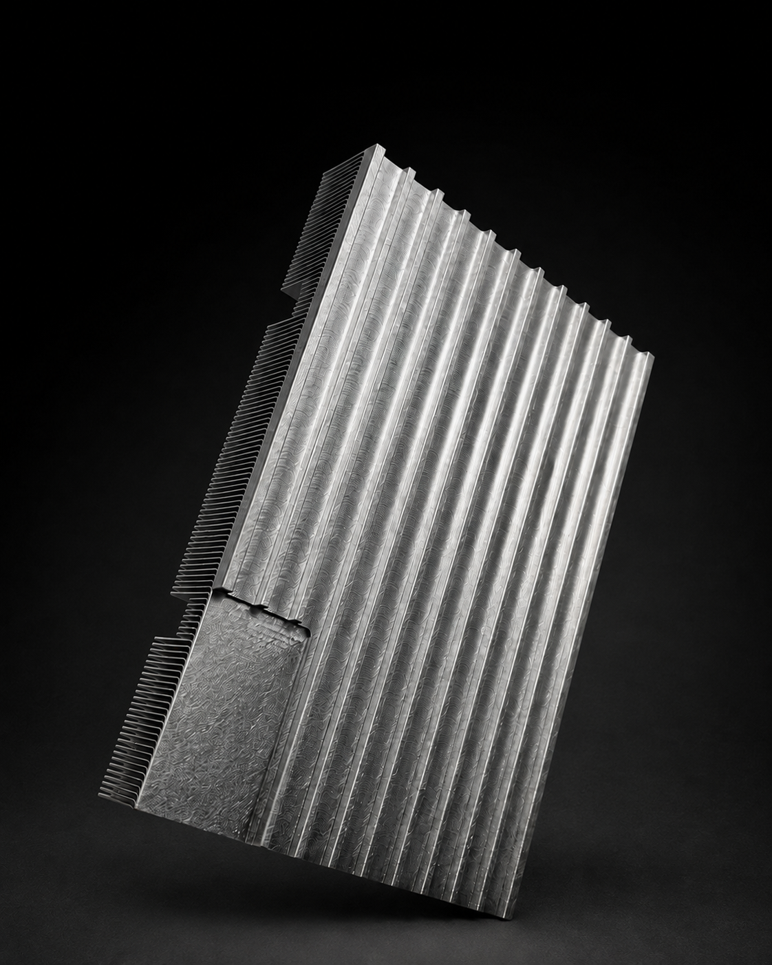Close view of the machined metal face and fins of a cooling component.