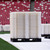 Stacked white modular flooring panels on a pallet inside a stadium.