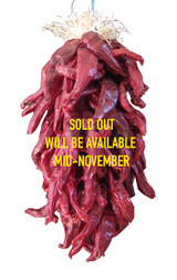 The measurement is the chile portion of the ristra only.  There is an additional 5" -7" of string above the ristra that is used for hanging it.