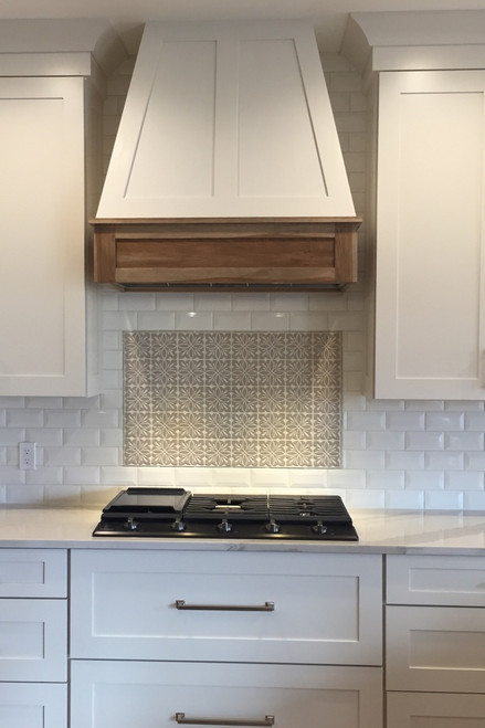 Beautiful White Farmhouse Kitchen with Decorative Tile Backsplash and Wooden Oven Hood
