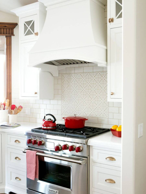 White kitchen with Cobham handmade tile accent above range and subway tile backsplash