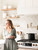Damask handmade tile backsplash in satin white with brass pot filler and range hood
