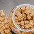 Nine Dozen Fat Sam's Pumpkin Peanut Butter CBD Infused Dog Treats in a beautiful glass cookie jar with black lid.