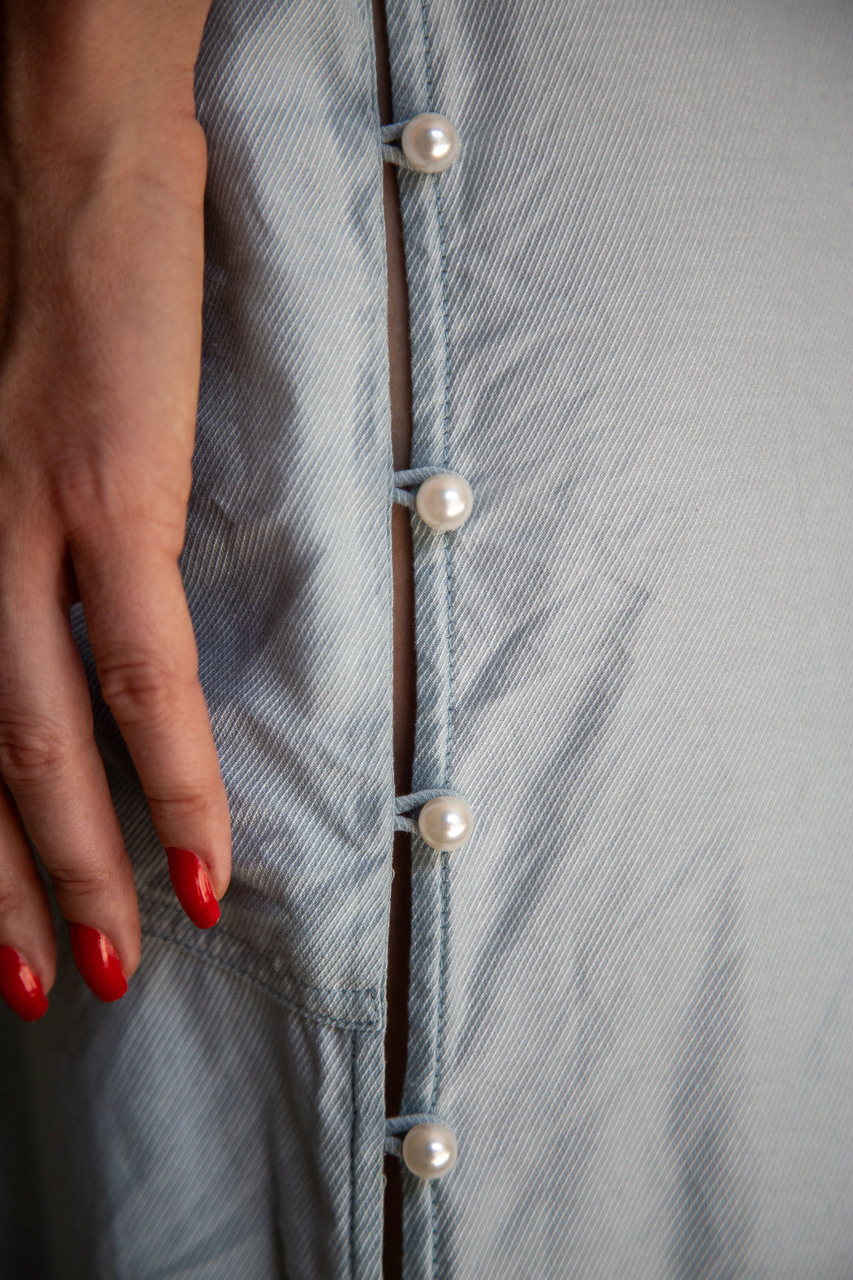 It’s all in the details: a graceful side closure with sophisticated pearl buttons adds a touch of vintage charm and effortless femininity
