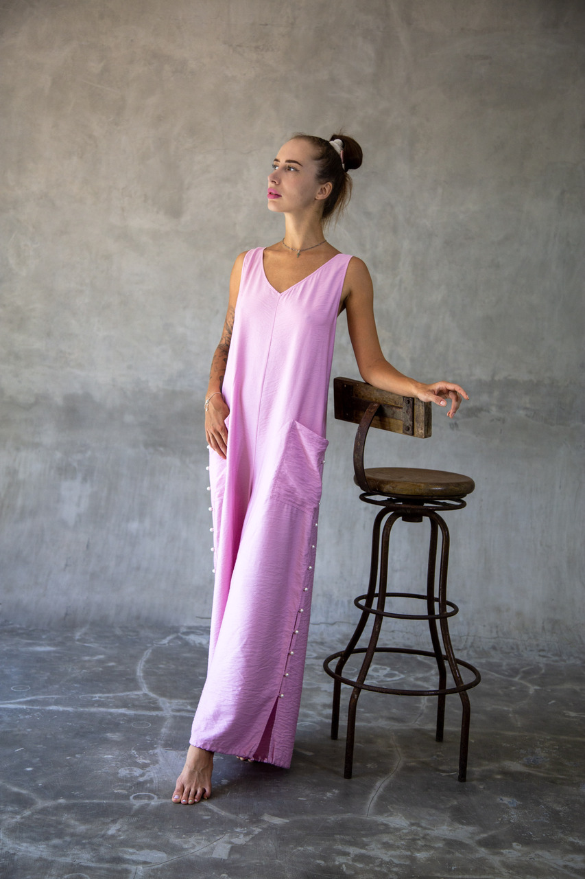 Elegant blush pink wide-leg jumpsuit with delicate spaghetti straps and flowing palazzo pants. Perfect for summer evenings and luxury resort wear. Shop the exclusive collection.Limited stock available