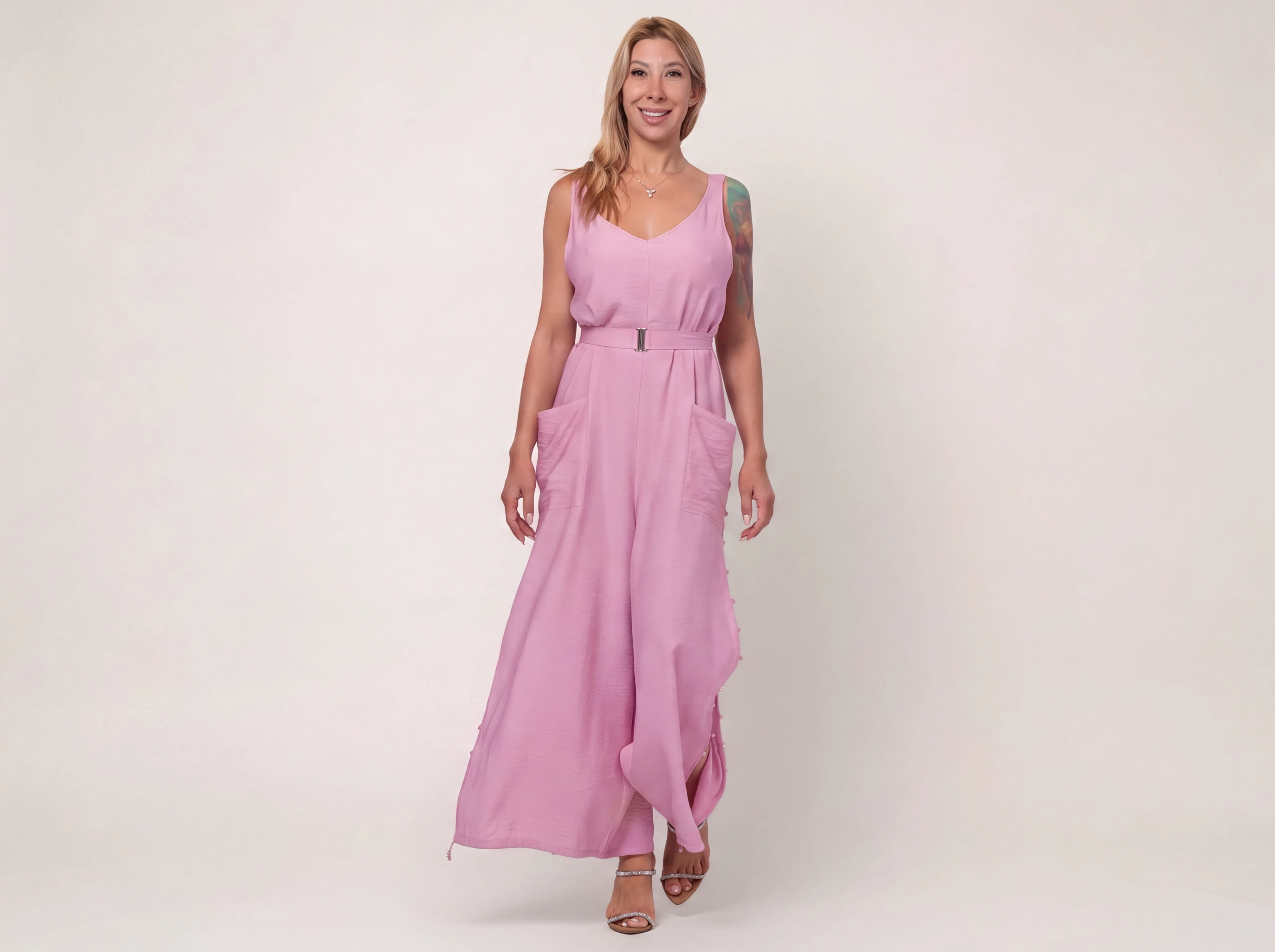 Full-length view of a woman wearing the ELUVARE pink palazzo jumpsuit
