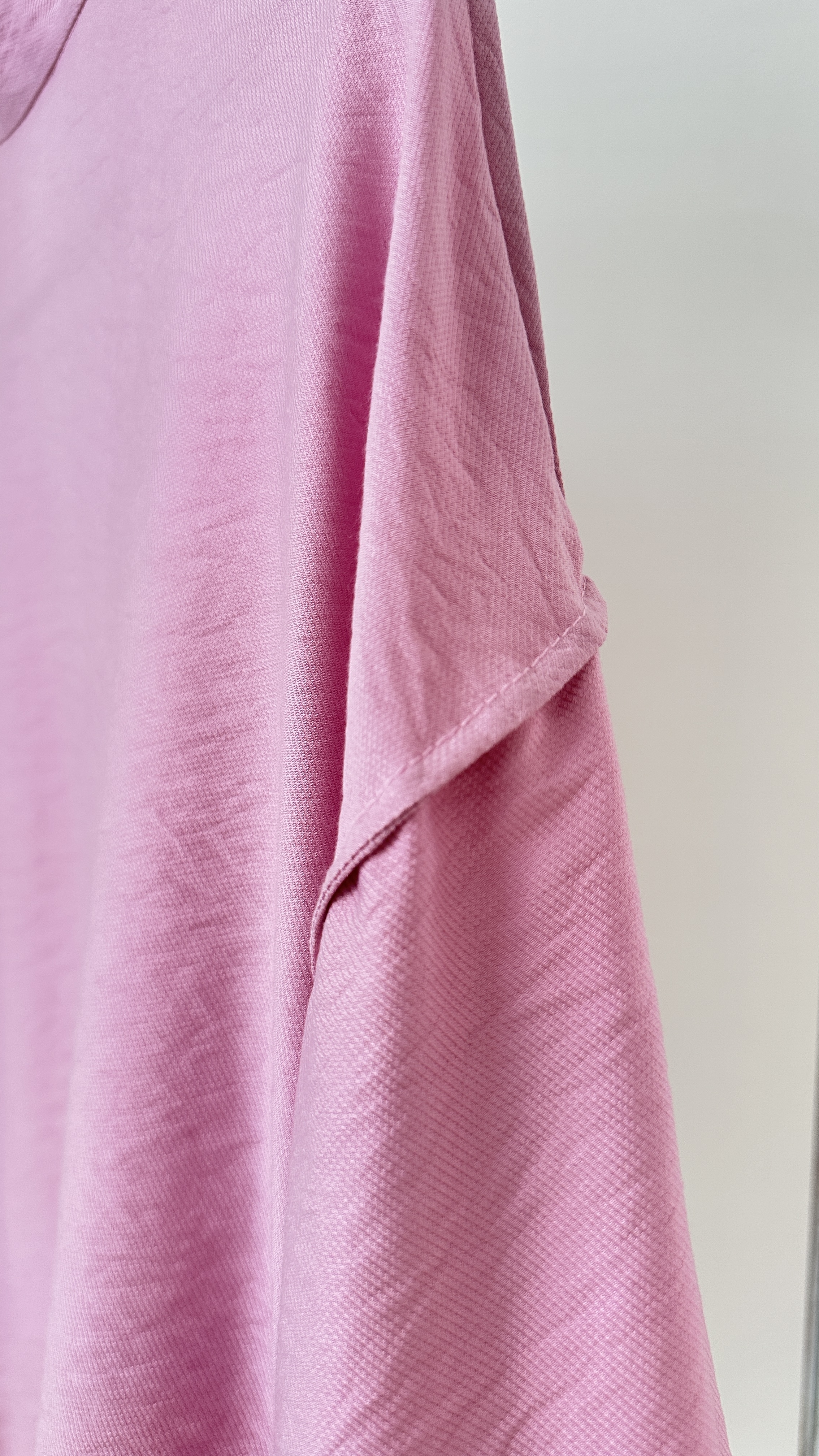 Fabric / wrong side Detail
Pink bomber jacket inside detail  show flowing lightweight fabric and delicate white lace accents.