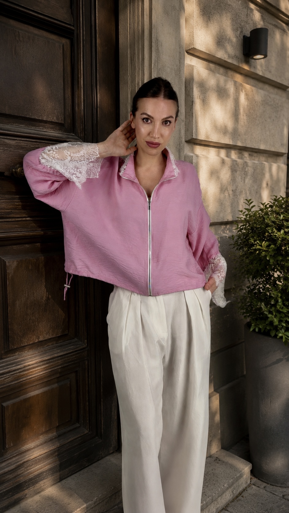 Zip-up pink bomber jacket featuring lace trim and relaxed fit details