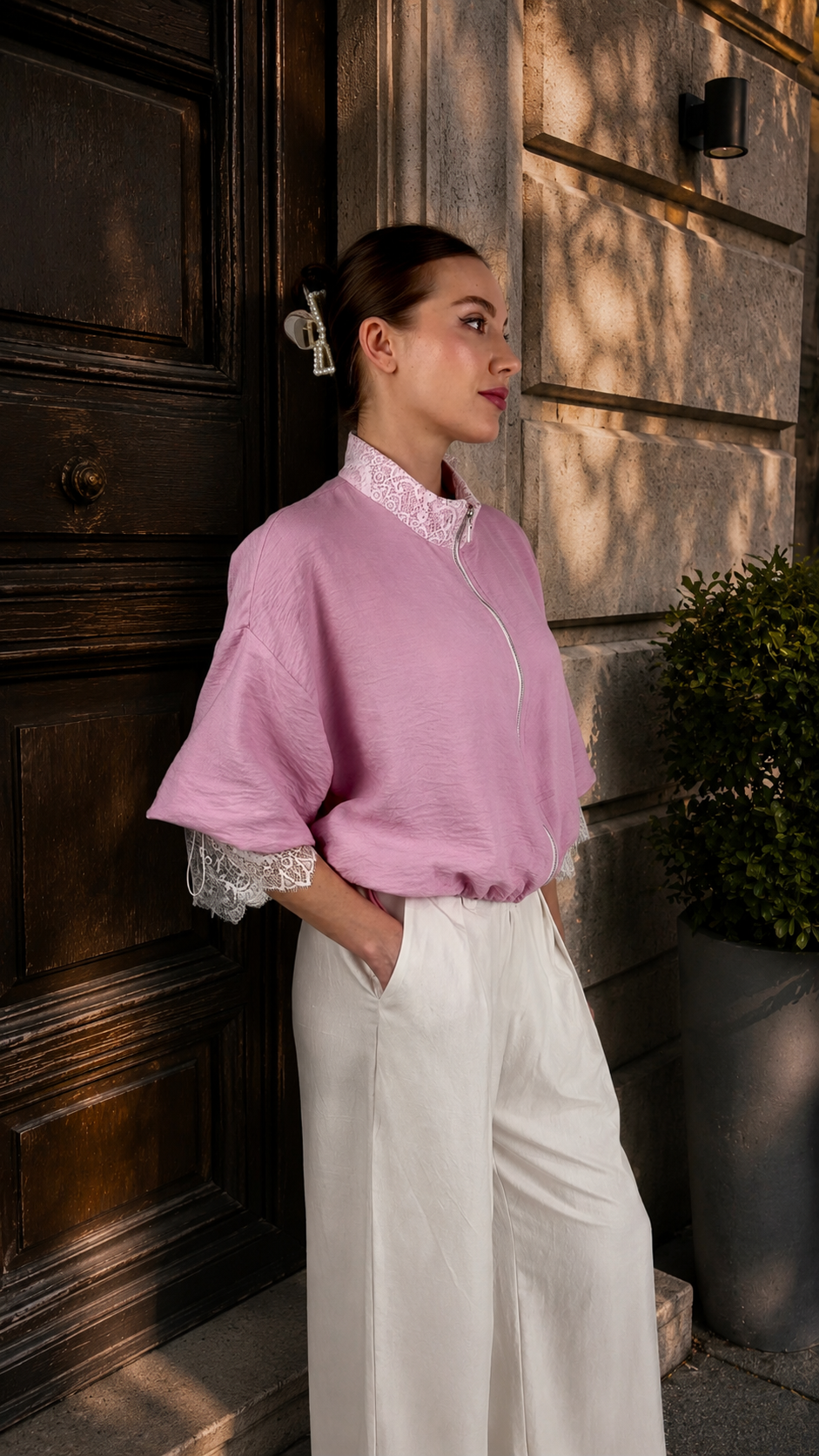 Pink lace bomber jacket zipper close-up showing hardware and fabric detail
