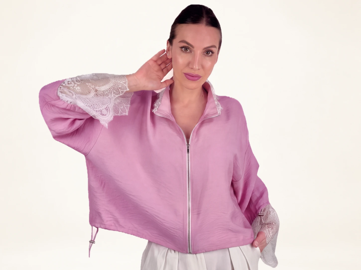 Elegant pink bomber jacket with lace cuffs and relaxed shape, available in limited quantities at Eluvare