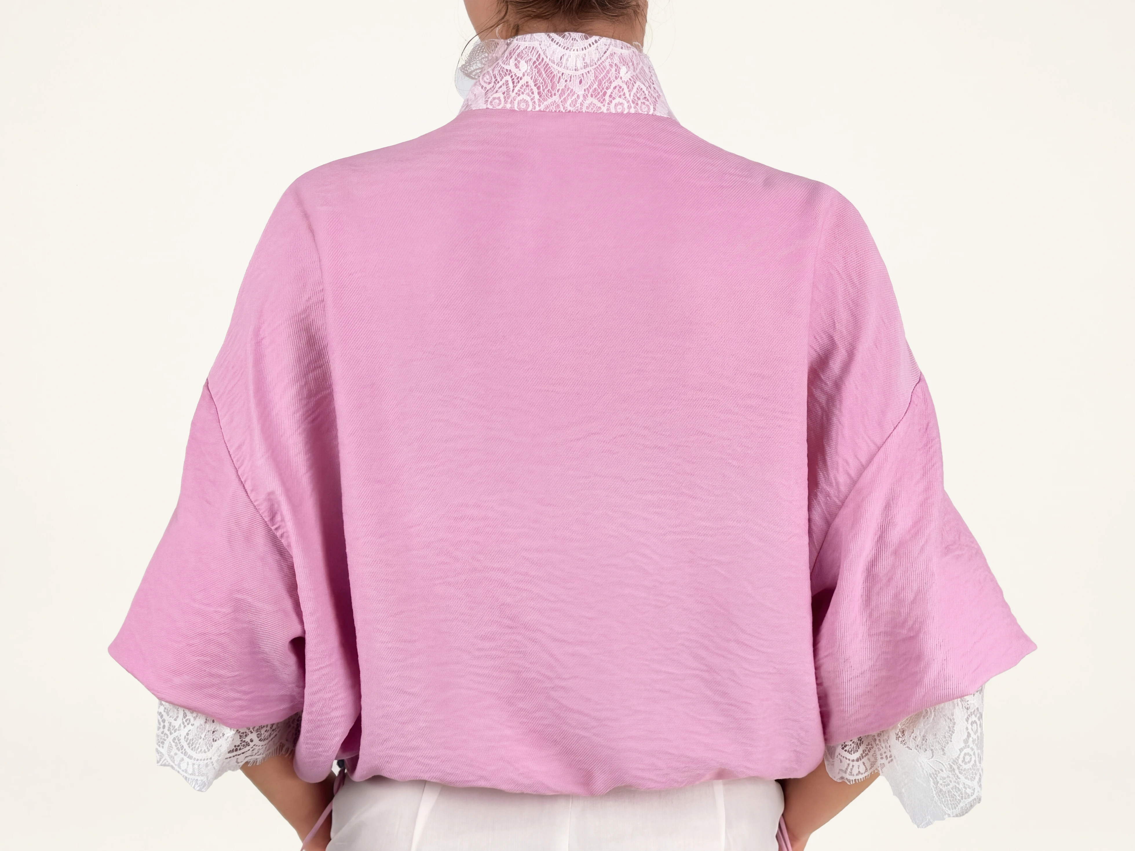 Elegant pink bomber jacket with lace cuffs and relaxed shape, available in limited quantities at Eluvare