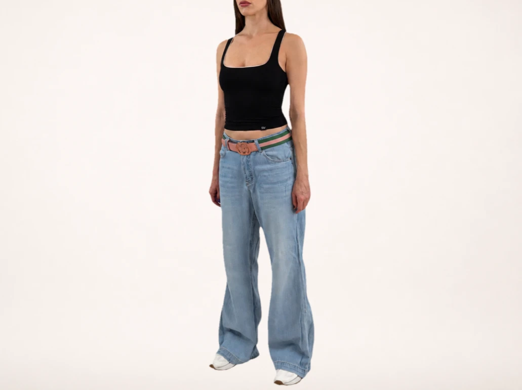 Model wearing ELUVARE black reversible top with jeans, elevated casual style