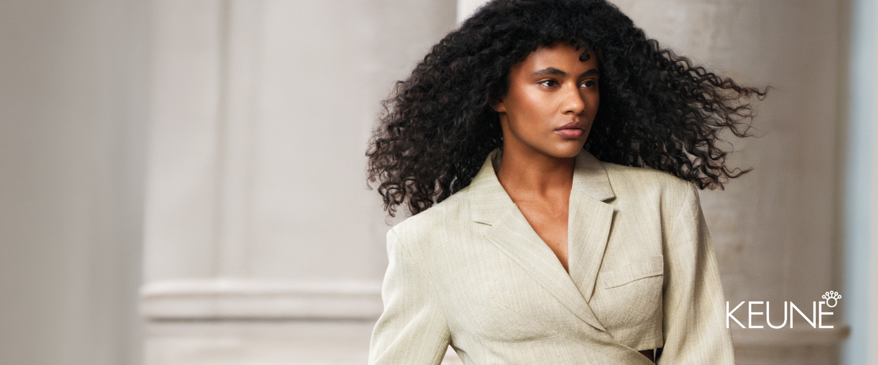 Keune Styling collection — model showcasing defined curly hair in professional editorial setting.