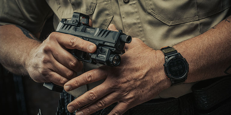 Close up of man holding handgun with a weapon light attached