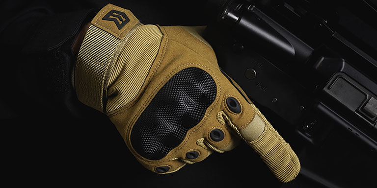 Coyote tactical glove holding rifle grip