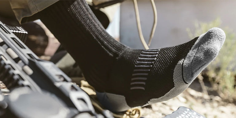 Foot in sock resting on ground