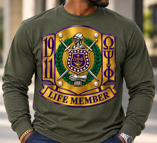LIFE MEMBER Crest Collection

Celebrate a lifetime of brotherhood, commitment, and legacy with our LIFE MEMBER Crest Collection. Designed to make a distinguished statement, this premium piece transforms the traditional Omega Psi Phi Life Member crest into a bold, elevated work of wearable art.

The design features a richly detailed 1911 crest, complete with the knight’s helmet, crossed swords, laurel wreath, shield, pearls, lamp, and armored gauntlet. Deep royal purple, old gold, emerald green, and polished silver tones give the artwork a dimensional, luxury finish, while the commanding LIFE MEMBER banner proudly completes the design.

Created for the Life Member who understands that membership is more than a moment—it represents years of service, brotherhood, achievement, and an enduring commitment to Omega Psi Phi Fraternity, Inc.

Available on select short-sleeve tees, long-sleeve tees, and premium crewneck sweatshirts in Purple, Old Gold, Pewter Green, and Cream.

Details: Premium full-color crest artwork • Rich dimensional detailing • Bold Life Member presentation • Designed for an elevated, distinguished look • Ideal for chapter events, homecoming, reunions, conferences, or everyday wear

LIFE MEMBER — Brotherhood for a lifetime. Legacy for generations.