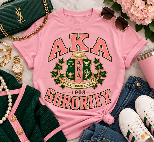 Merit & Grace is a sophisticated celebration of Alpha Kappa Alpha heritage, bringing timeless collegiate styling together with an elevated, fashion-forward finish. Designed in signature pink and deep green with realistic old-gold detailing, this piece makes a statement without sacrificing elegance.

The centerpiece features an intricate sorority-inspired crest framed by beautifully detailed ivy with gold trim, while bold collegiate lettering gives the design its classic university influence. “By Merit and By Culture” and 1908 complete the composition, honoring a legacy rooted in scholarship, service, sisterhood, and excellence.

Created for the woman who loves her Greek apparel just as polished as the rest of her wardrobe, Merit & Grace transitions effortlessly from casual to sophisticated. Style it with denim and sneakers for an elevated everyday look, or layer the crewneck over a crisp Oxford with tailored trousers, heels, pearls, and gold accessories.

Design Details: Signature pink, deep green and realistic old gold • Detailed ivy accents • Collegiate-inspired typography • “By Merit and By Culture” and 1908 details • Clean, crisp full-color print with no distressed or vintage treatment • Available on select short-sleeve, long-sleeve and crewneck options.

Each piece is made to order. Please allow approximately 5–7 business days for processing prior to shipment.

Merit & Grace — where legacy meets effortless sophistication.