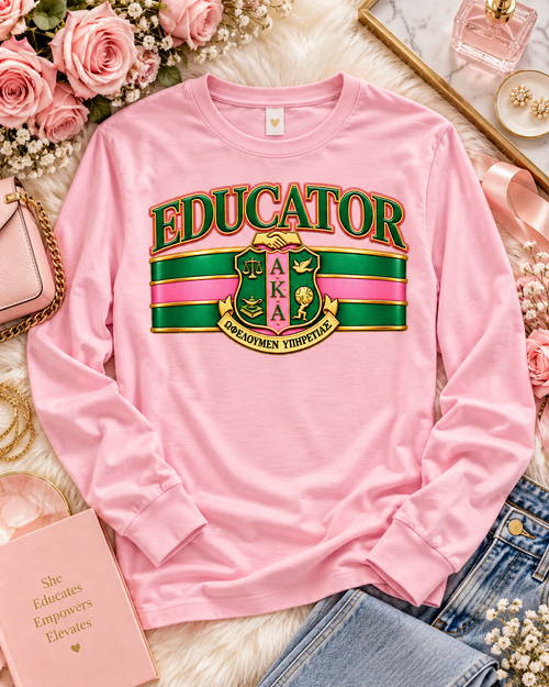 Celebrate the educators who lead with knowledge, purpose, and service. The AKA Educator design blends timeless collegiate styling with an elevated Alpha Kappa Alpha–inspired aesthetic, featuring bold EDUCATOR lettering, signature pink and green striping, rich gold detailing, and a distinguished crest centerpiece.

Designed for teachers, professors, administrators, counselors, and education professionals, this piece honors the women who shape minds, strengthen communities, and create lasting impact through education. The polished, almost embossed look gives the design a luxe finish while still keeping it versatile enough for classrooms, conferences, chapter events, educator celebrations, and everyday AKA style.

Available on select tees, long sleeves, and sweatshirts.

Made to order. Please allow 5–7 business days for processing before shipment.