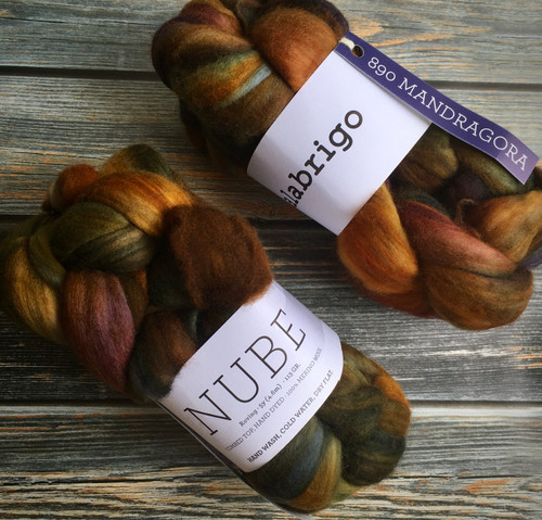 Malabrigo Nube Wool Roving - Hand Dyed 100% Merino Fiber Combed Top, 4oz, Mandragora color with earthy tones of brown, orange, and green for spinning and felting purposes.