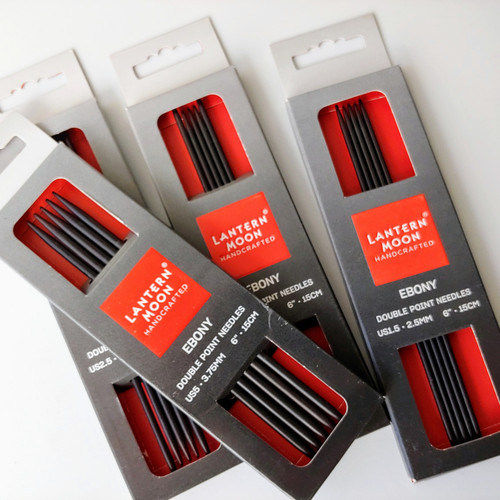 Lantern Moon Ebony DPNs, handcrafted luxury double pointed knitting needles, black ebony wood, red packaging, set of needles.