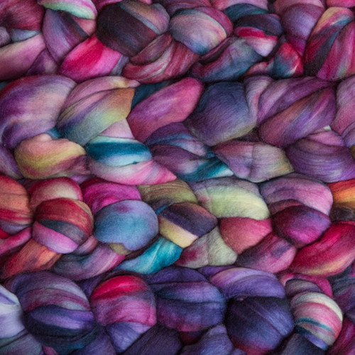 Malabrigo Nube Boreal, 100% Merino Wool Roving, multicolored fiber in shades of pink, purple, blue, and yellow, for spinning and felting.
