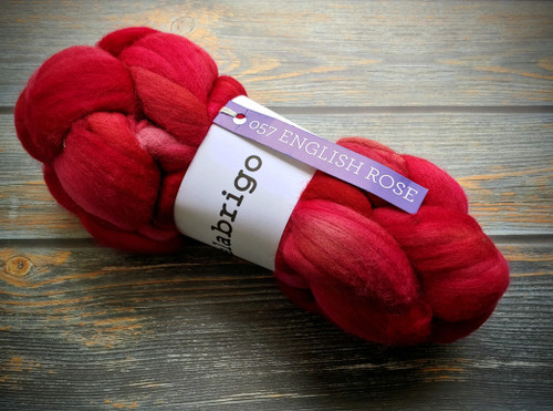 Malabrigo Nube English Rose 100% Merino Wool Roving, 4oz spinning and felting fiber, vibrant red color, on wooden background, Merino wool roving product.