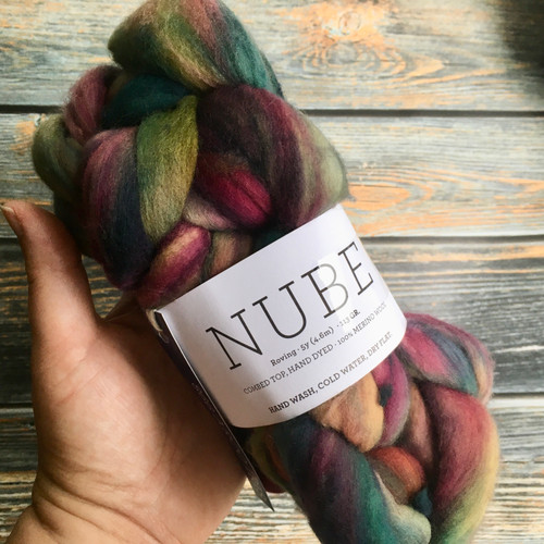 Malabrigo Nube Arco Iris 4oz merino wool roving in multicolored shades of pink, green, and orange, suitable for spinning and felting fiber crafts by Malabrigo brand.