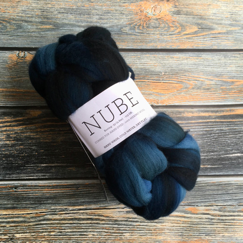 Malabrigo Nube Deep Ocean 100% Merino Wool Roving, 4oz, featuring dark blue and black hues, perfect for spinning and felting fiber crafts made by fiber artist.