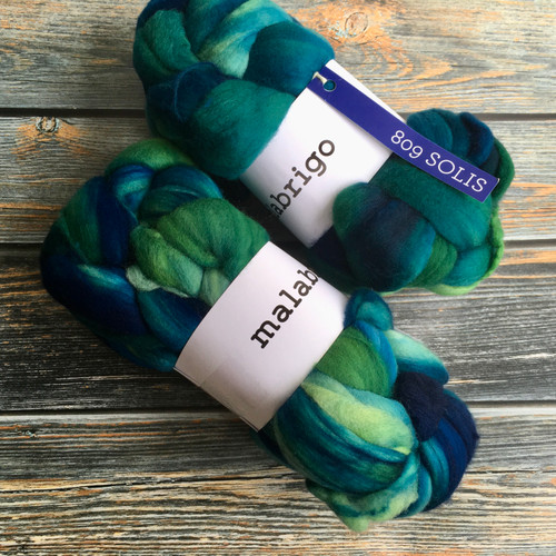 Malabrigo Nube Solis 100% Merino Wool Roving, 4oz roving fiber bundle in vibrant blue and green hues, for spinning and felting, from Malabrigo brand, 100% wool fiber.