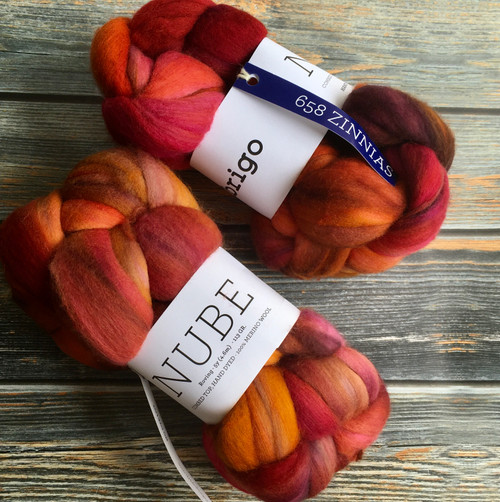 Malabrigo Nube Wool Roving in vibrant red, orange, and yellow hues, 100% Merino Fiber, combed top, 4oz, hand-dyed by Malabrigo brand for spinning and felting supplies.