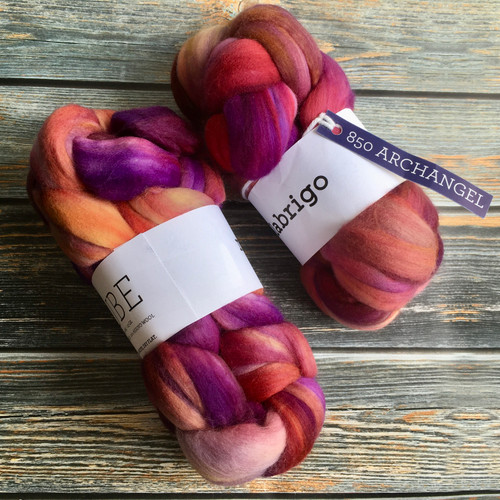 Malabrigo Nube Wool Roving Archangel, 100% hand-dyed merino fiber combed top, vibrant pink, purple, and orange hues, 4oz weight, perfect for spinning and felting crafts.
