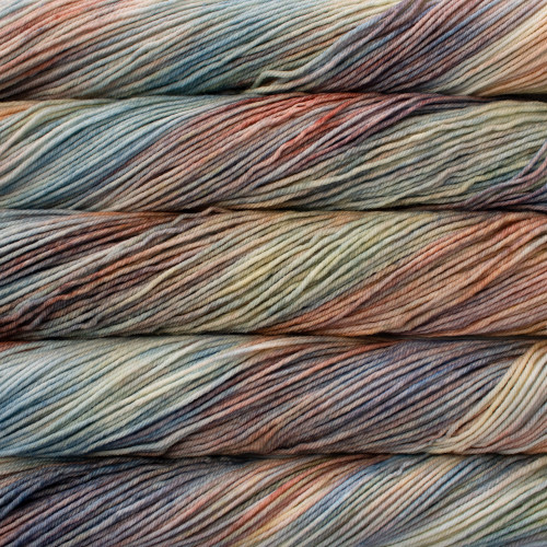 Malabrigo Rios Zahara Superwash Merino Worsted yarn skeins in a colorful, marbled pattern of blue, orange, beige, and gray hues.
