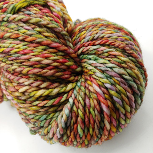 Bulky Handspun Merino Wool Yarn, A Walk Home Artisan 2-Ply, multicolored yarn with shades of red, green, yellow, and pink.