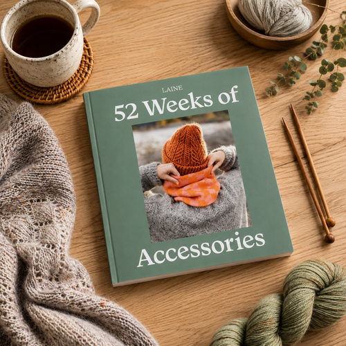Laine Publishing's 52 Weeks of Accessories book with green cover and orange knitted hat on woman, surrounded by yarn and knitting needles.