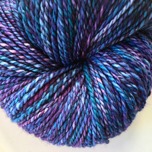 Luxury Blueberry Haze Merino yarn skein in bulky weight, featuring a blend of blue, purple, and pink hues in a handspun texture.
