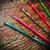 KnitPro Dreamz Wooden Crochet Hook Set, vibrant colorful hooks in pink, green, silver, red, and multicolor, laid on wooden surface.