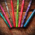 KnitPro Dreamz Wooden Crochet Hook Set, vibrant colorful hooks in assorted sizes and colors including pink, green, red, purple, and blue, arranged on wood.
