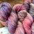 Forever Winding Wool Hand Painted Worsted Weight Wool Yarn from West Virginia Hills, featuring multi-colored pink, purple, and beige hues, worsted weight yarn in speckled texture.