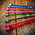 Knitter's Pride Dreamz 10” & 14” wooden knitting needles, displayed on a natural surface, showcasing assorted colors and brand's signature wooden design.