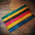 Knitter's Pride Dreamz DPN double pointed needles arranged in colorful stripes, 6" (15.24cm), featuring wooden construction and white size labeling, by popular brand Knitter's Pride for sock knitting.