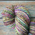 Forever Winding Wool handspun luxurious merino wool yarn, vibrantly hand-dyed in multicolored shades of pink, green, blue, and purple, 100% pure wool, crafted from natural materials.