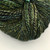 Luxury Blue Spruce Handspun Merino Yarn, DK Sport Weight, multicolored blue, green, and black hues, showcasing artisan craftsmanship in a skein.