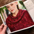 Woman wearing a vibrant red knitted cowl-neck shawl, Malabrigo Book 13: Shawl Road, showcasing a stylish, chunky knitwear in a rich burgundy color.