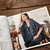 Malabrigo pattern book #17 Ponchos & Familia, woman wearing blue poncho sitting on chair, showcasing stylish poncho design from the book.